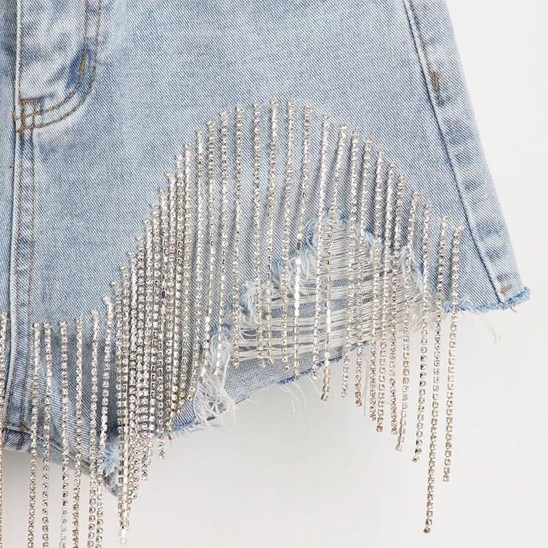 Women luxurious tassel rhinestone fringed hole jeans shorts, high waist design, showcasing stylish details and a flattering fit.