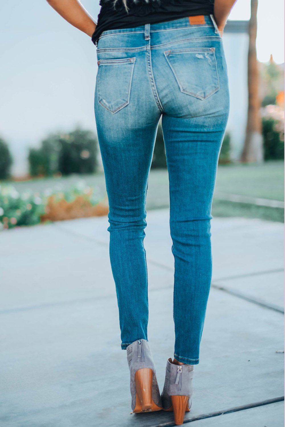 A pair of Women's Fashion Red Plaid Patch Destroyed Skinny Jeans featuring distressed details, plaid patches on the front legs, and a skinny fit silhouette.