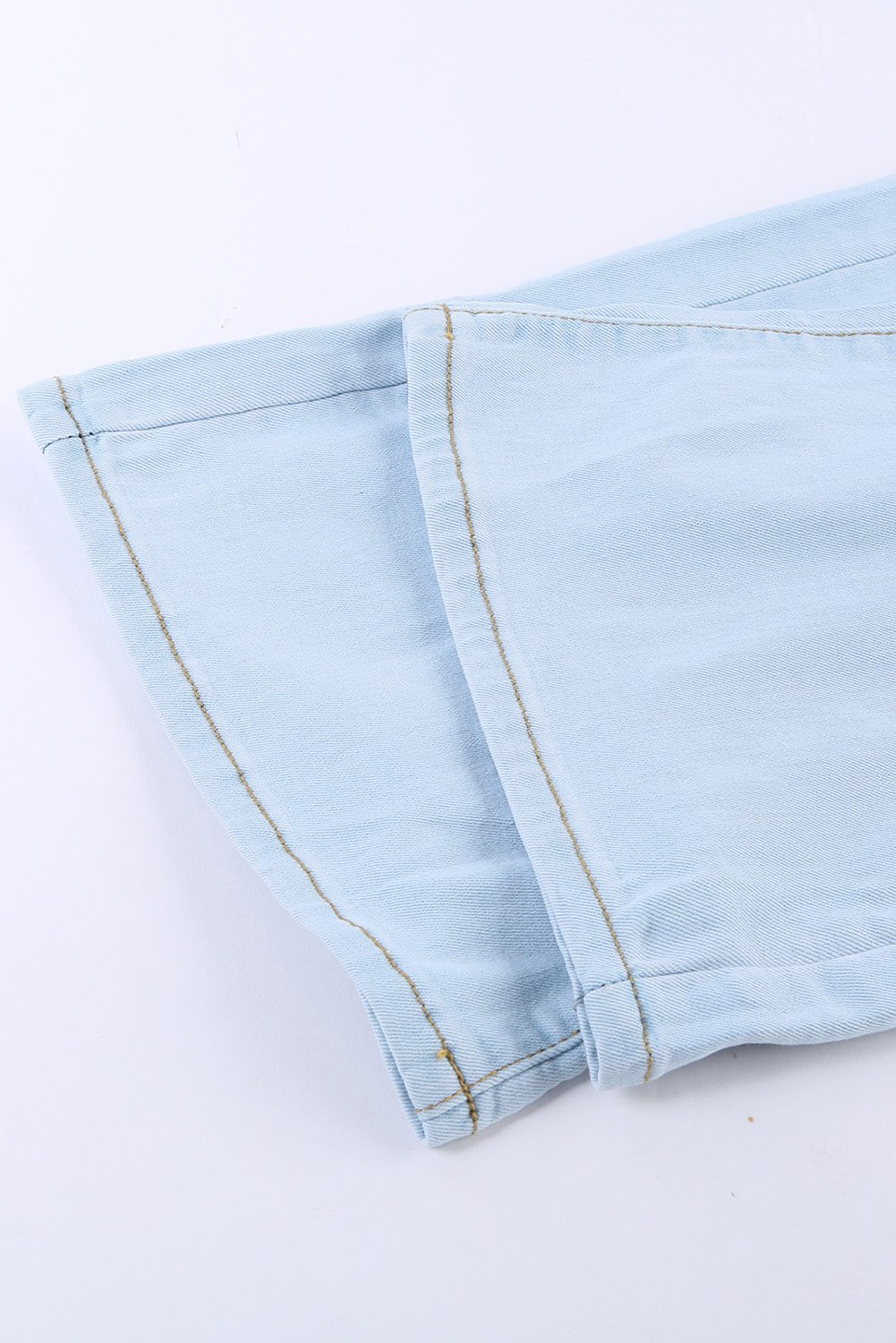 A pair of women's sky blue washed ripped knee wide-leg jeans, featuring a high-rise design and button fly closure, displayed on a white background.