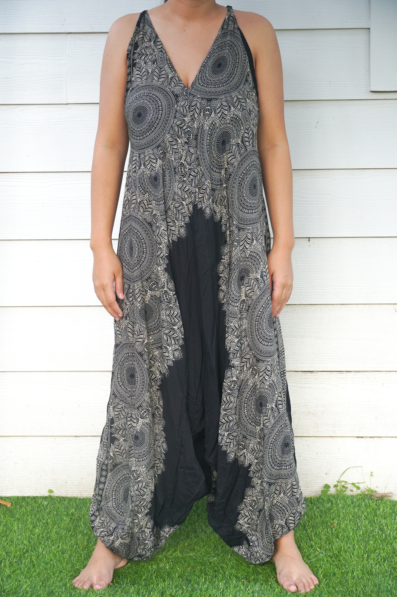 Black Lotus Boho Hippie Jumpsuit featuring wide legs, adjustable straps, and elasticated back, made from soft breathable rayon fabric.