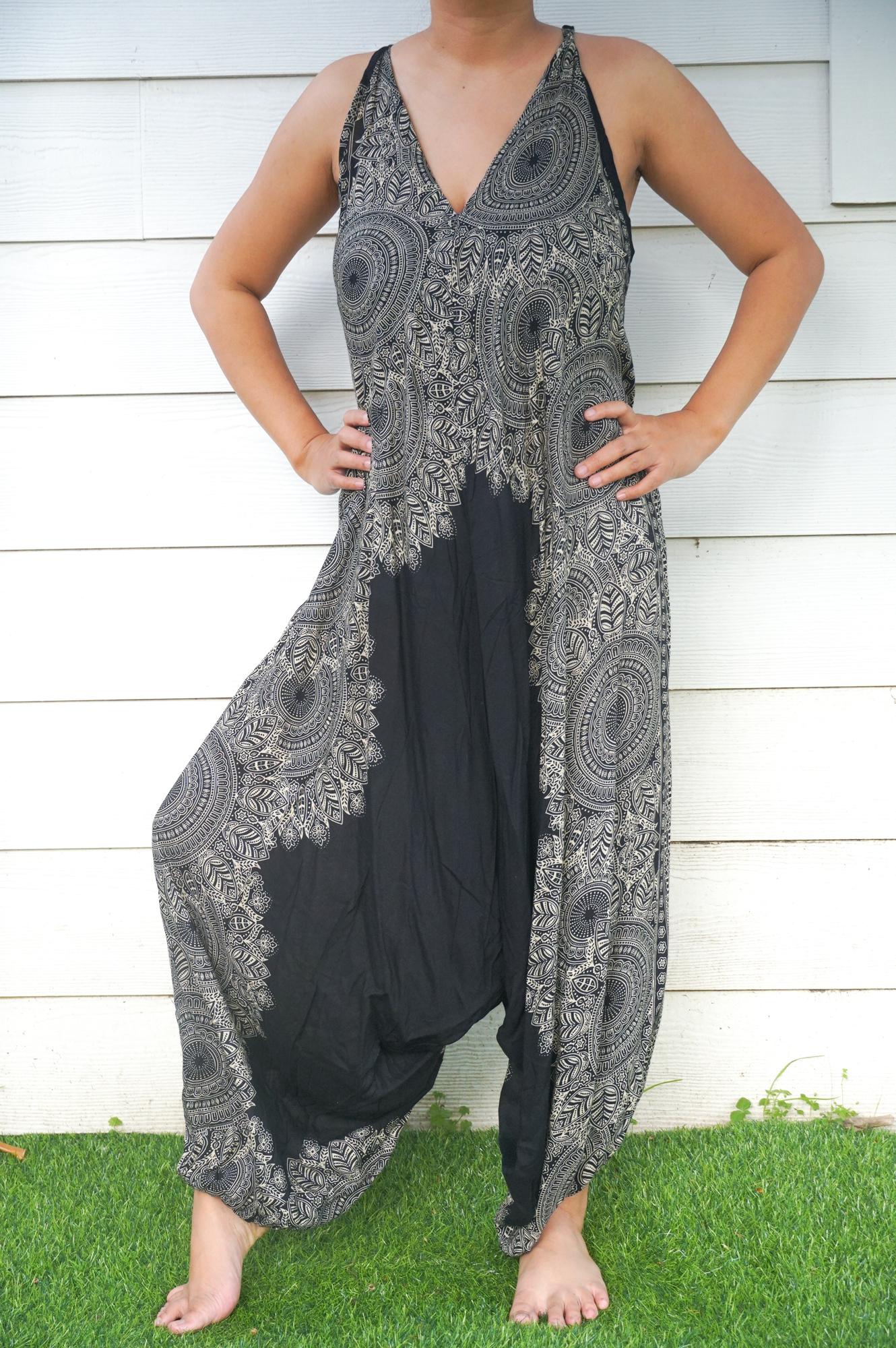 Black Lotus Boho Hippie Jumpsuit featuring wide legs, adjustable straps, and elasticated back, made from soft breathable rayon fabric.