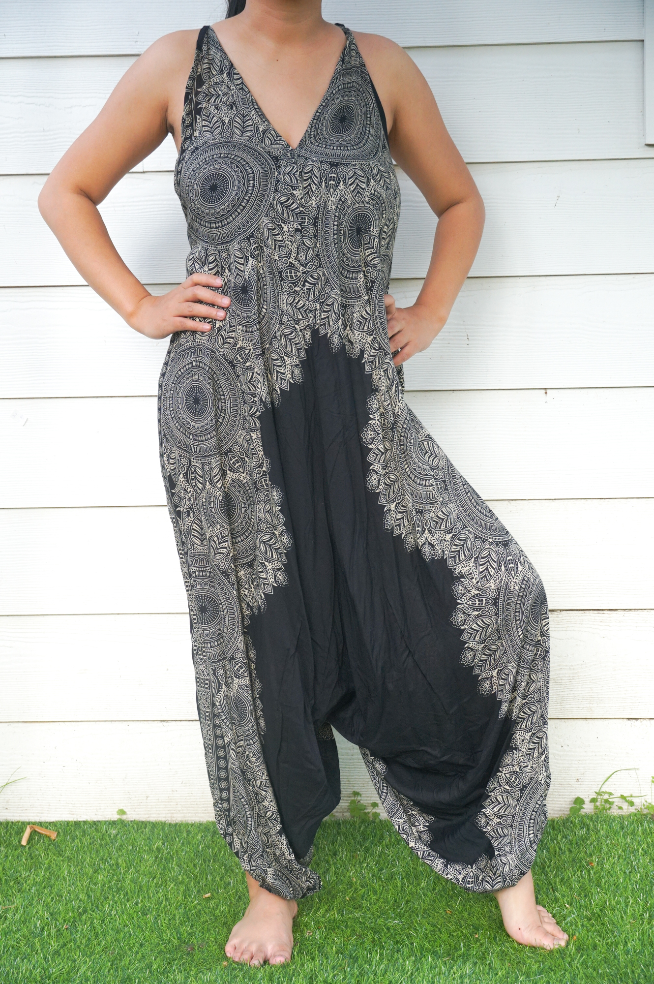 Black Lotus Boho Hippie Jumpsuit featuring wide legs, adjustable straps, and elasticated back, made from soft breathable rayon fabric.