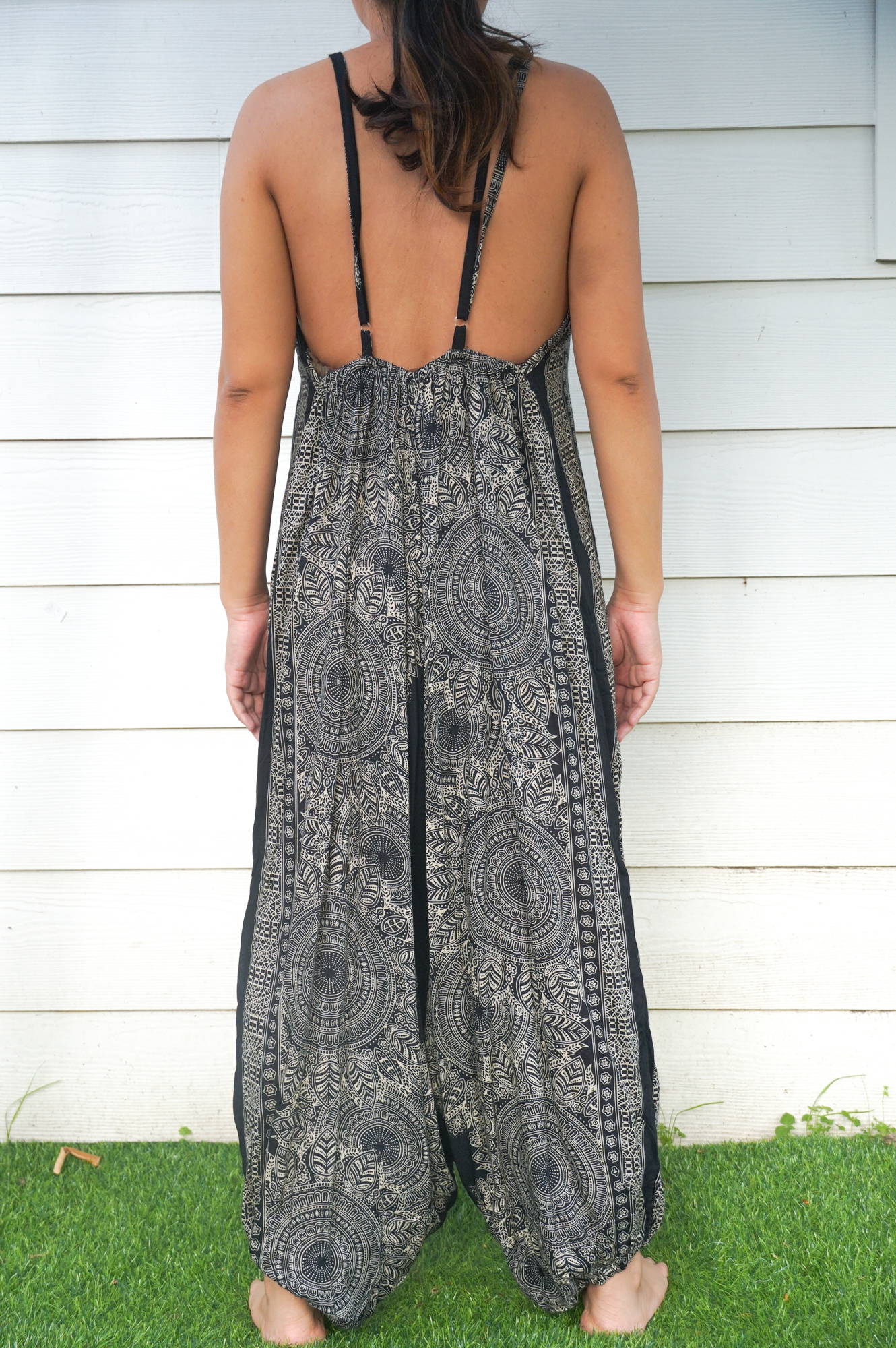 Black Lotus Boho Hippie Jumpsuit featuring wide legs, adjustable straps, and elasticated back, made from soft breathable rayon fabric.