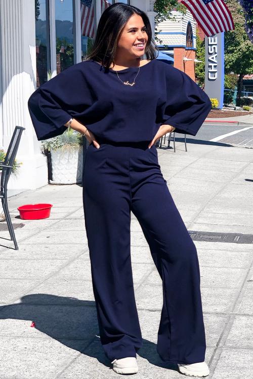 A stylish blue Bracelet Sleeve Waist Tie Wide Leg Jumpsuit featuring 3/4 sleeves, a boat neckline, and a key-hole back detail, perfect for day-to-night wear.