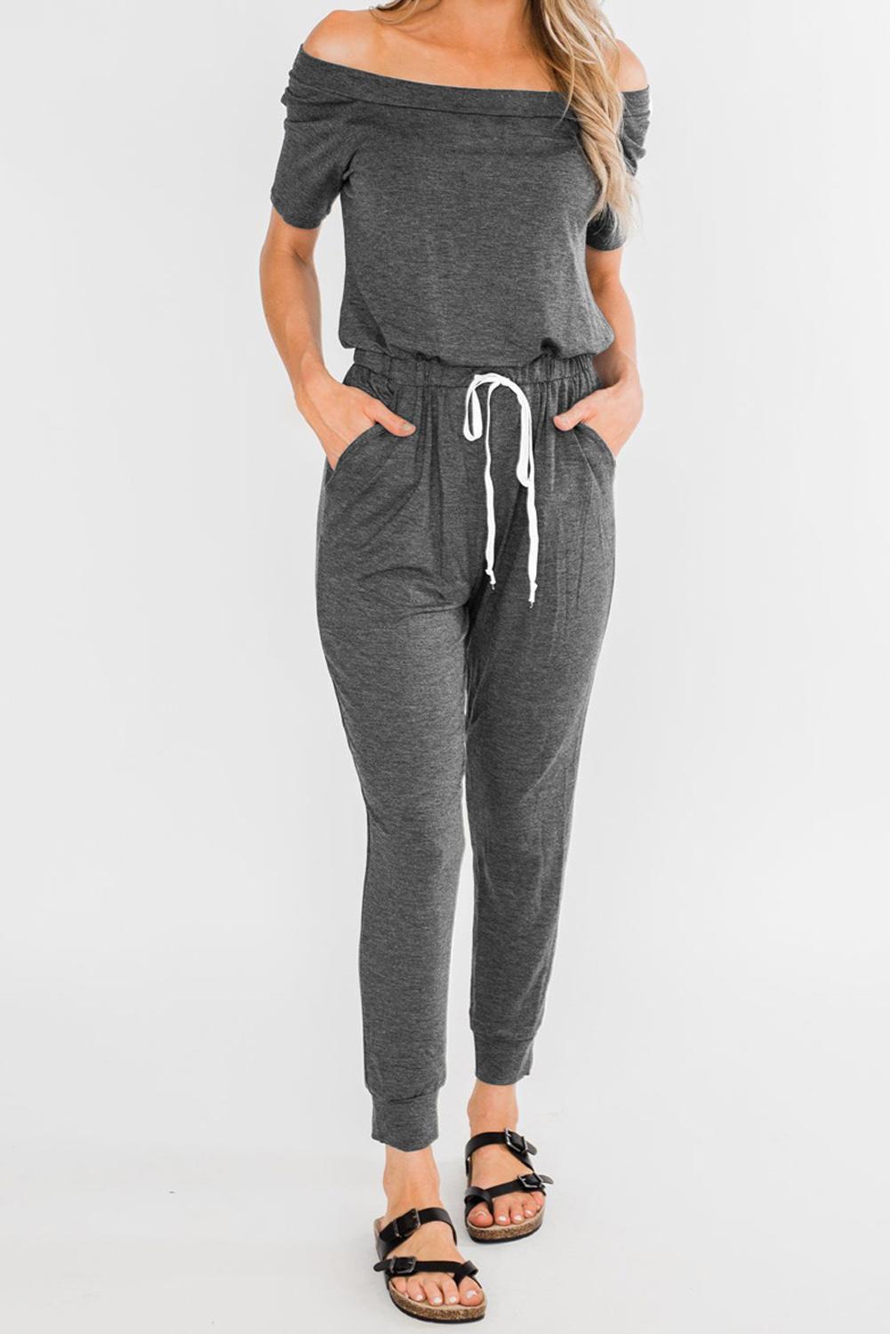 Gray off-the-shoulder drawstring jogger jumpsuit featuring short sleeves and pockets, perfect for summer casual wear.