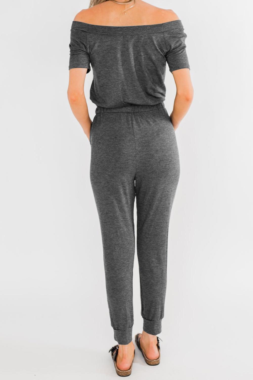 Gray off-the-shoulder drawstring jogger jumpsuit featuring short sleeves and pockets, perfect for summer casual wear.