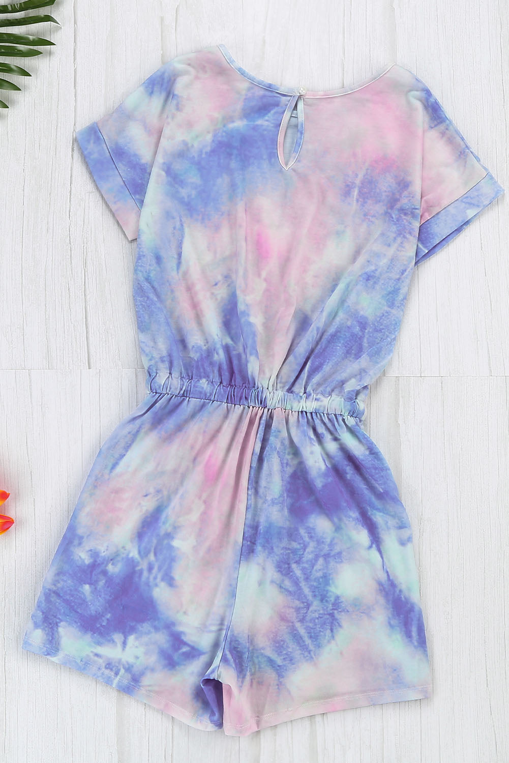 Multicolor Pocketed Tie Dye Short Sleeve Knit Romper featuring a vibrant tie-dye pattern, short sleeves, and an elastic drawstring waist for a comfortable fit.