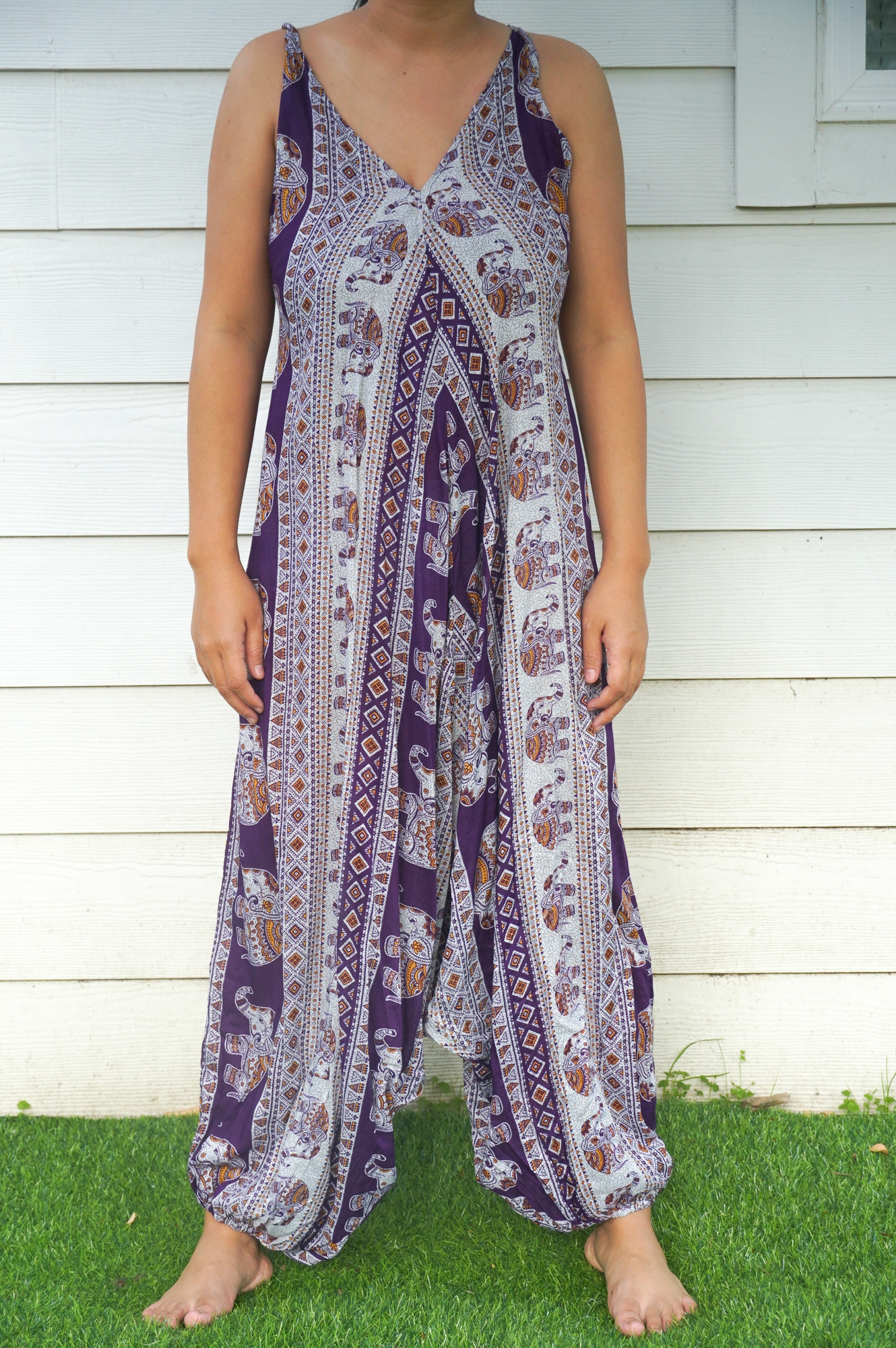 A vibrant Purple Elephant Boho Hippie Jumpsuit featuring wide legs, adjustable straps, and elasticated back, perfect for summer festivals.