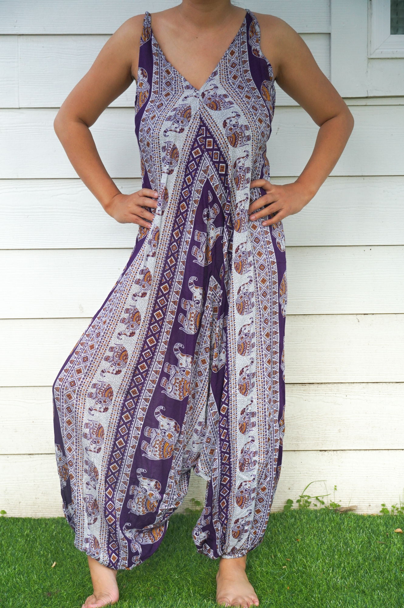 A vibrant Purple Elephant Boho Hippie Jumpsuit featuring wide legs, adjustable straps, and elasticated back, perfect for summer festivals.