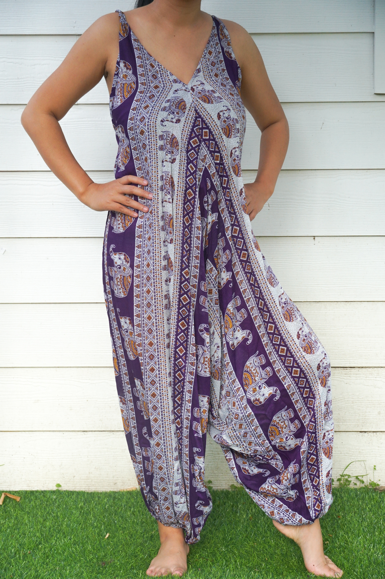 A vibrant Purple Elephant Boho Hippie Jumpsuit featuring wide legs, adjustable straps, and elasticated back, perfect for summer festivals.