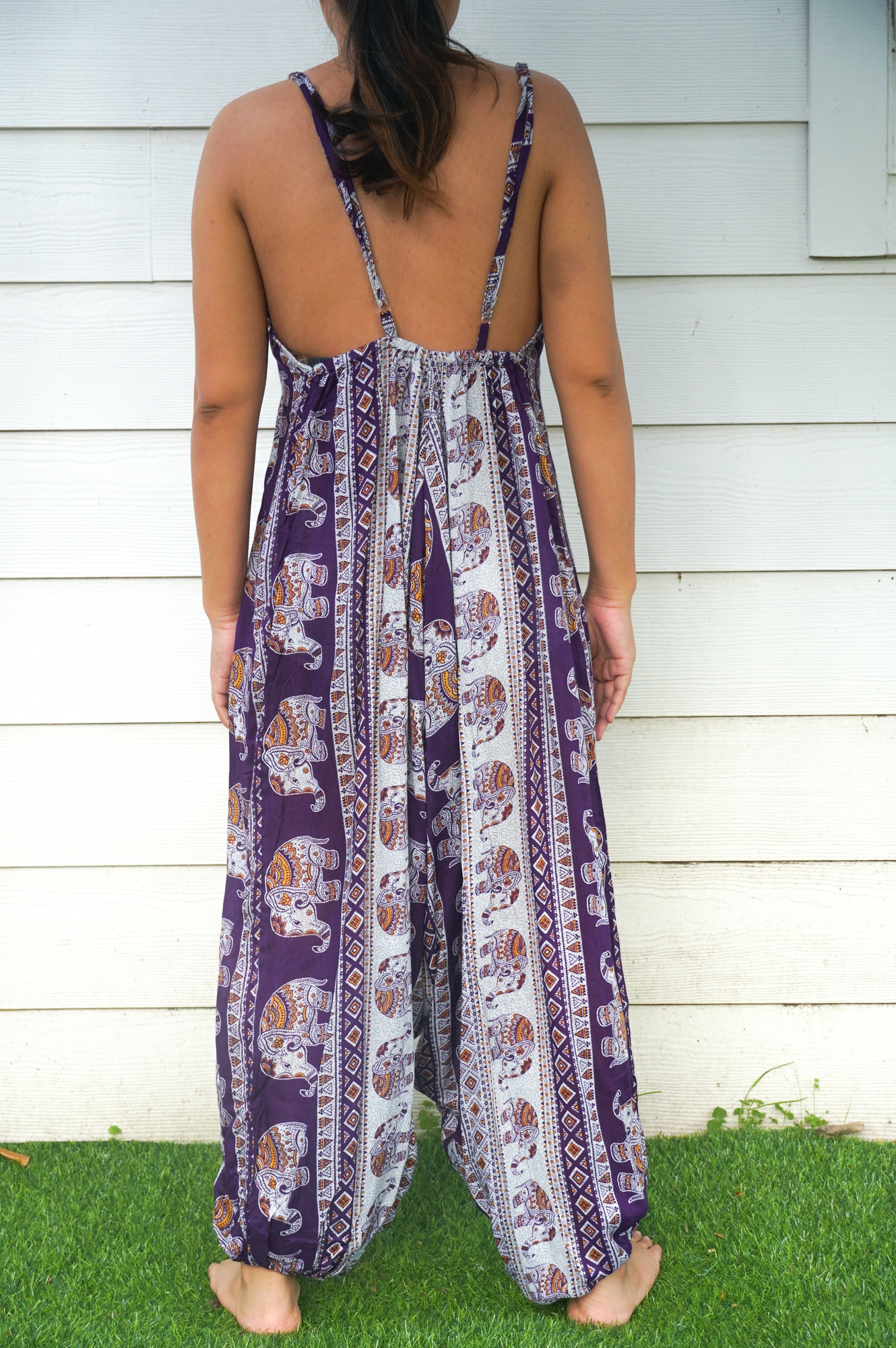 A vibrant Purple Elephant Boho Hippie Jumpsuit featuring wide legs, adjustable straps, and elasticated back, perfect for summer festivals.