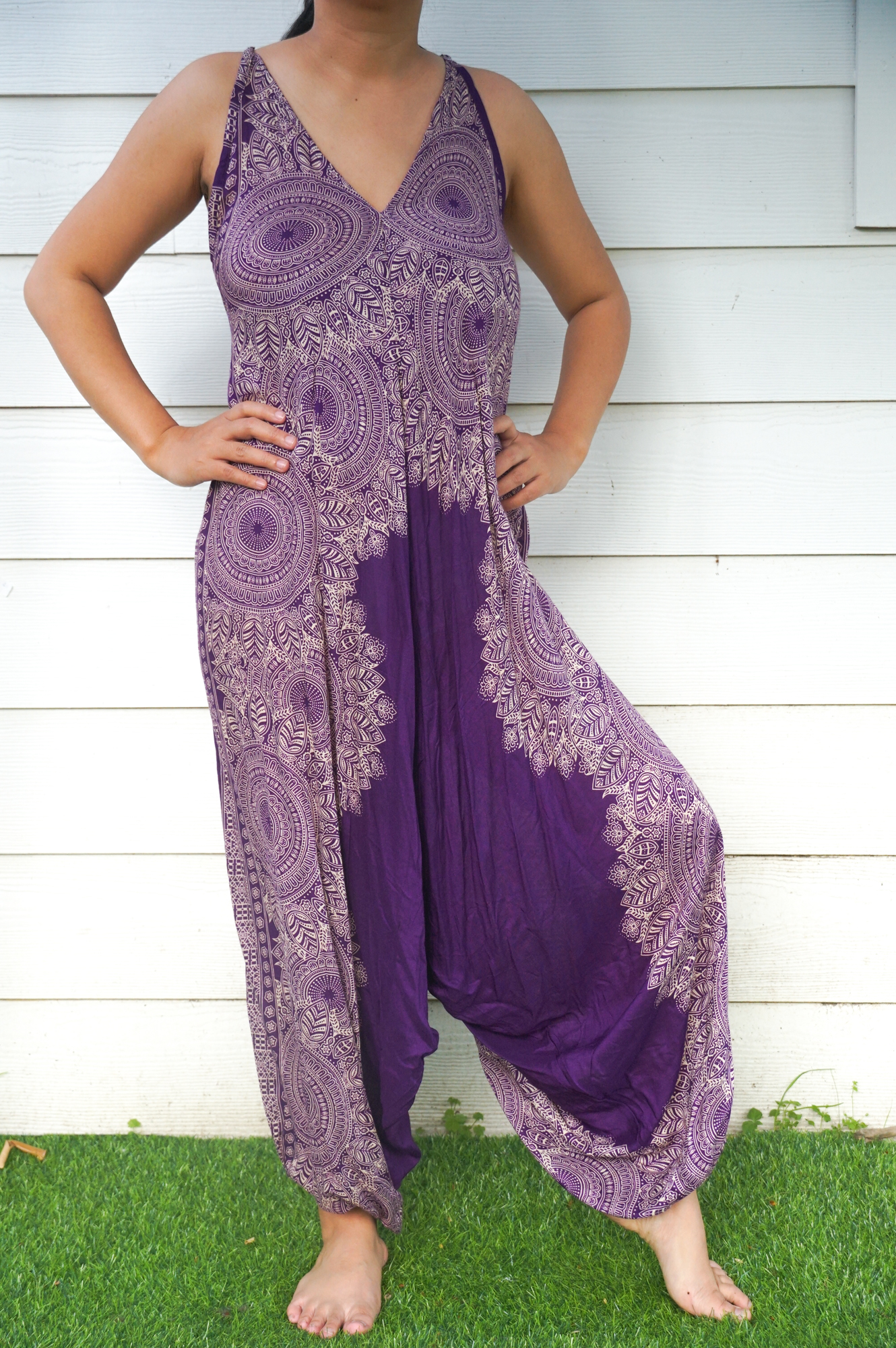 A vibrant Purple Lotus Hippie Jumpsuit featuring a boho design, wide legs, and adjustable straps, perfect for summer festivals.