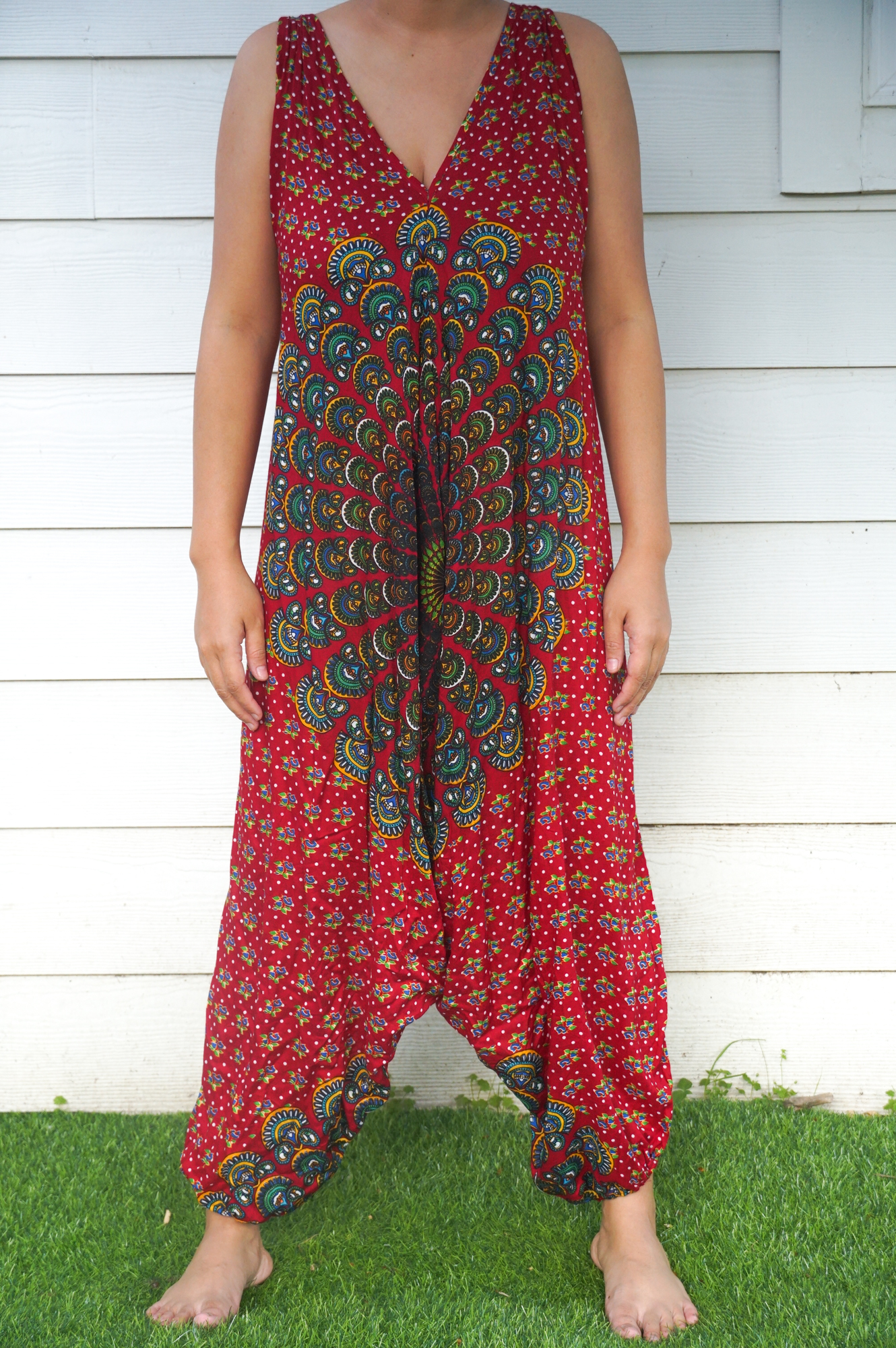 A vibrant Red Chakra Hippie Jumpsuit featuring wide legs, adjustable straps, and elasticated back, perfect for festivals and summer outings.