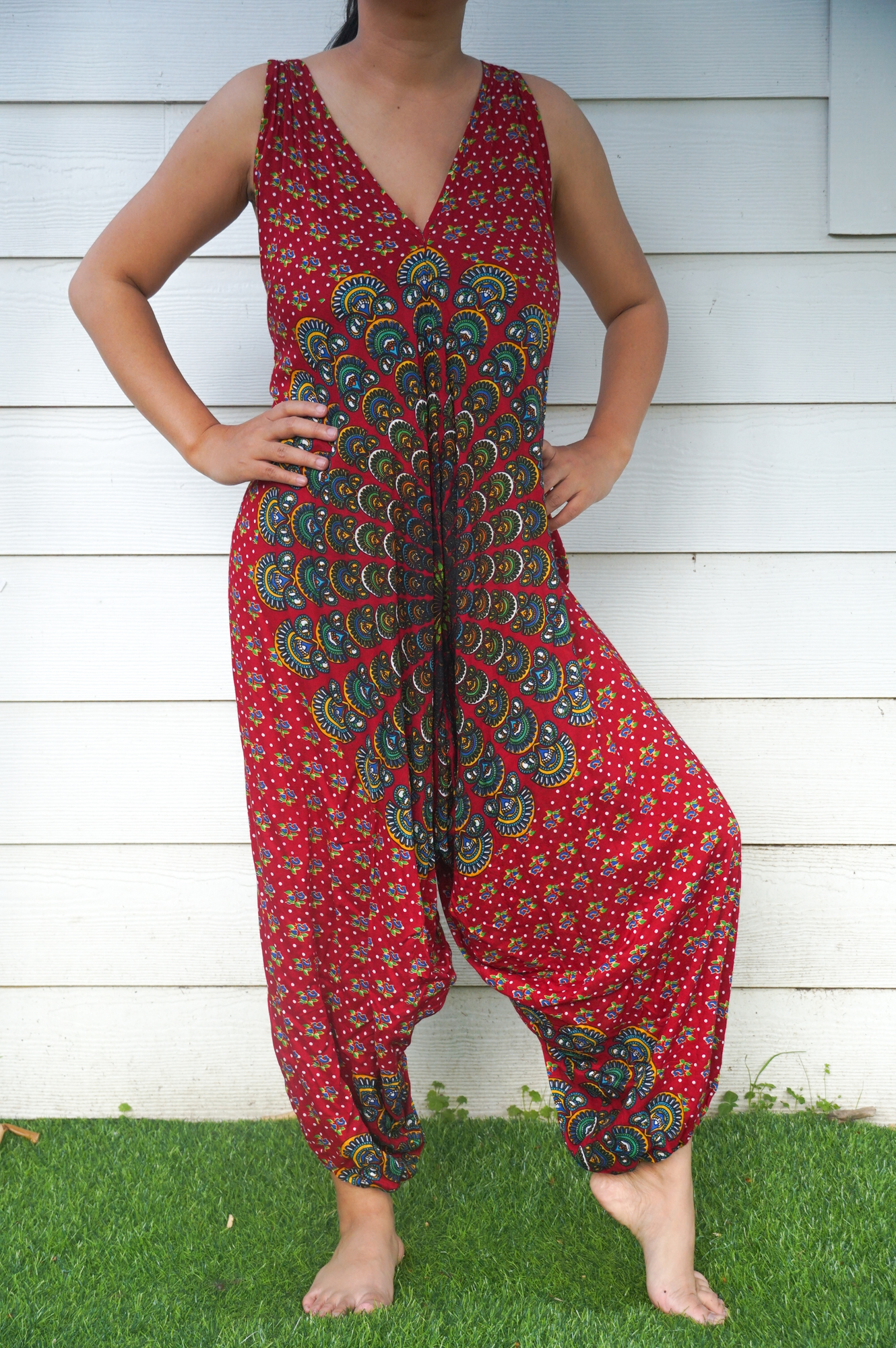 A vibrant Red Chakra Hippie Jumpsuit featuring wide legs, adjustable straps, and elasticated back, perfect for festivals and summer outings.