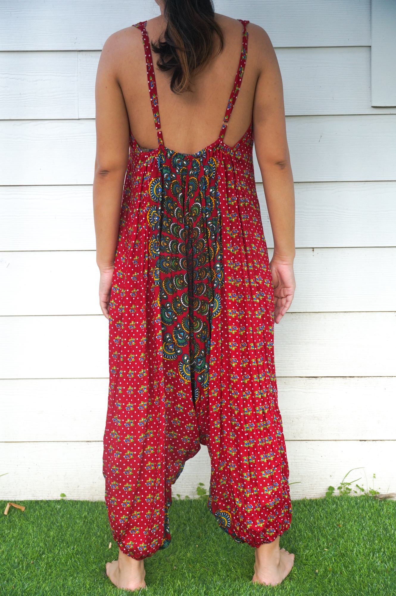 A vibrant Red Chakra Hippie Jumpsuit featuring wide legs, adjustable straps, and elasticated back, perfect for festivals and summer outings.