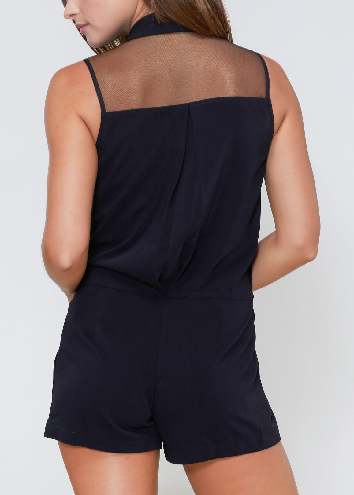 A stylish black V-neck sleeveless romper featuring a relaxed fit bodice and flowy shorts with hidden side pockets.