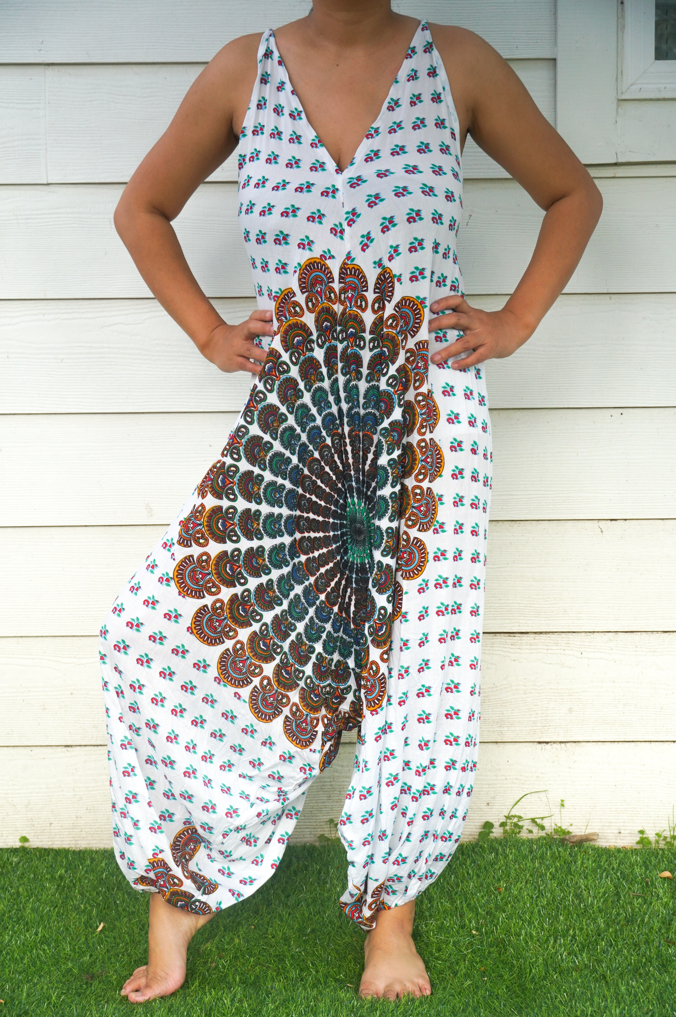 A stylish White Chakra Hippie Jumpsuit featuring wide legs, adjustable straps, and elasticated back, perfect for festivals and summer outings.