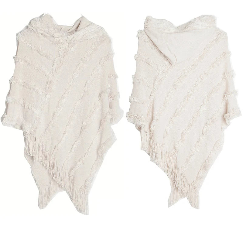 A stylish women winter knit hooded poncho cape with fringed edges, perfect for chilly weather and versatile for spring.