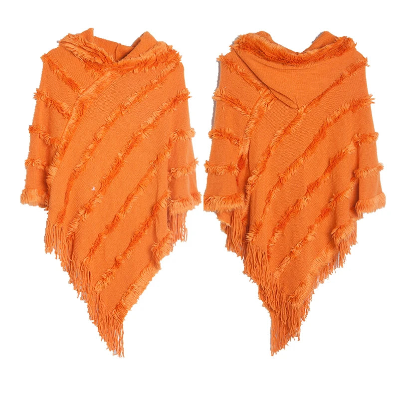 A stylish women winter knit hooded poncho cape with fringed edges, perfect for chilly weather and versatile for spring.