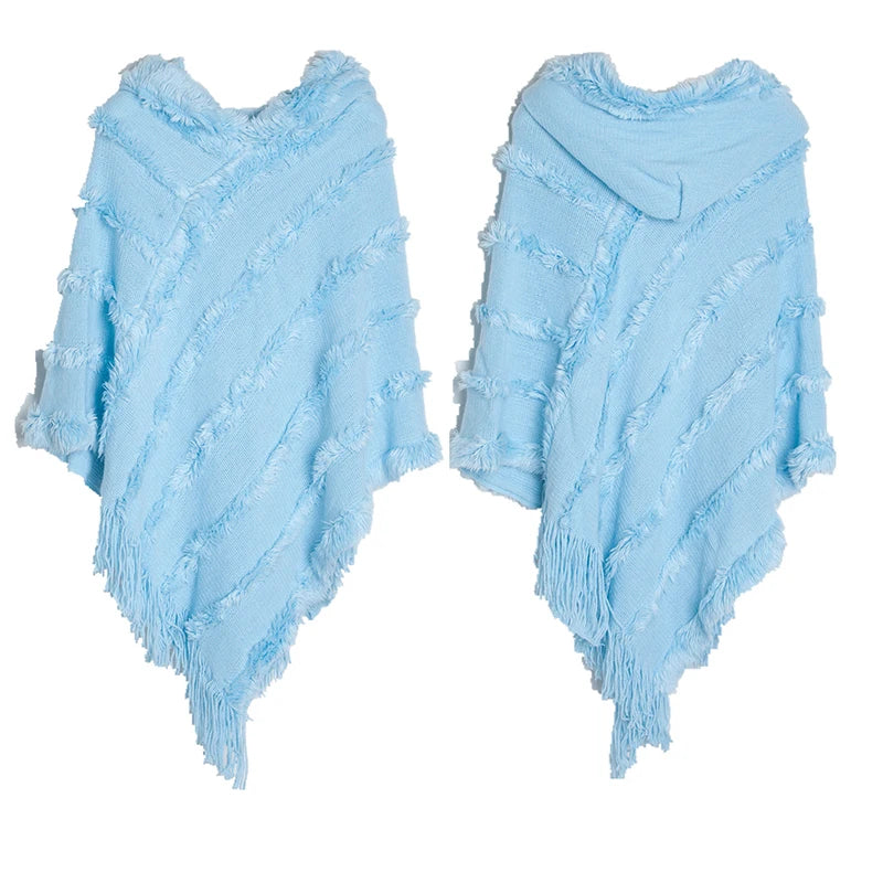 A stylish women winter knit hooded poncho cape with fringed edges, perfect for chilly weather and versatile for spring.