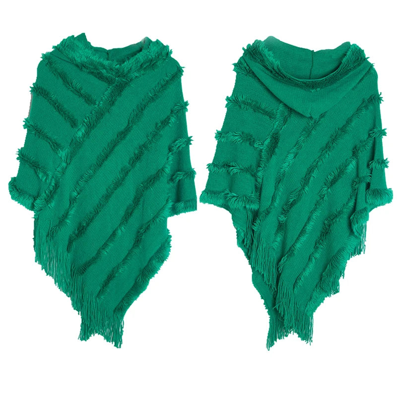 A stylish women winter knit hooded poncho cape with fringed edges, perfect for chilly weather and versatile for spring.