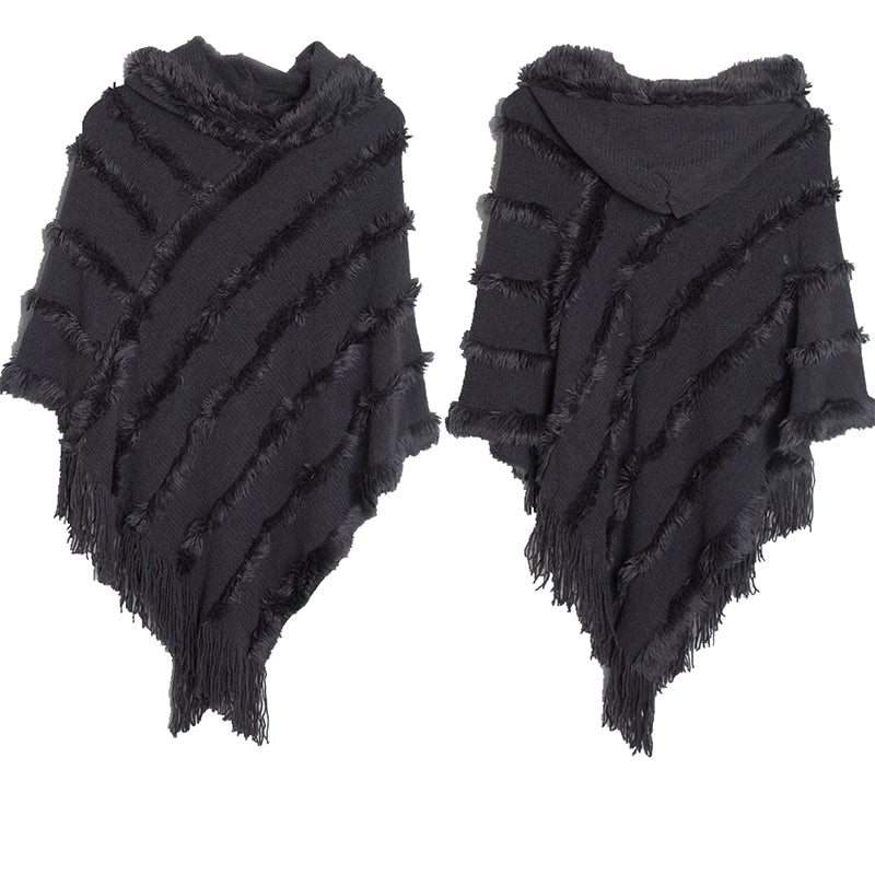 A stylish women winter knit hooded poncho cape with fringed edges, perfect for chilly weather and versatile for spring.