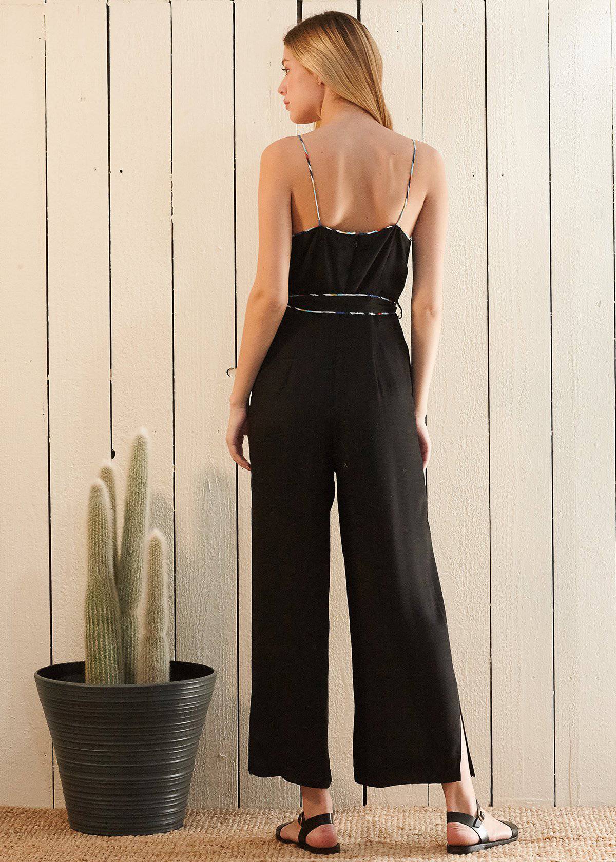 Women's black jumpsuit featuring multi-color binding, self-tie belt, and side pockets, perfect for various occasions.