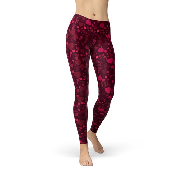 A pair of vibrant red women's leggings featuring a unique hearts design, showcasing their four-way stretch and squat-proof quality, perfect for workouts and casual wear.