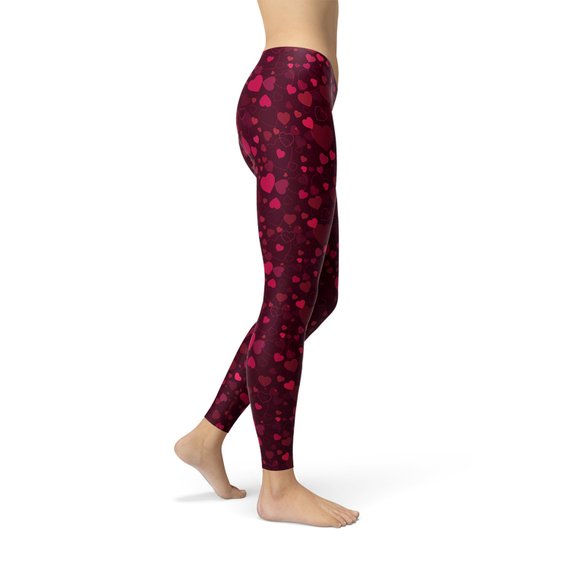 A pair of vibrant red women's leggings featuring a unique hearts design, showcasing their four-way stretch and squat-proof quality, perfect for workouts and casual wear.