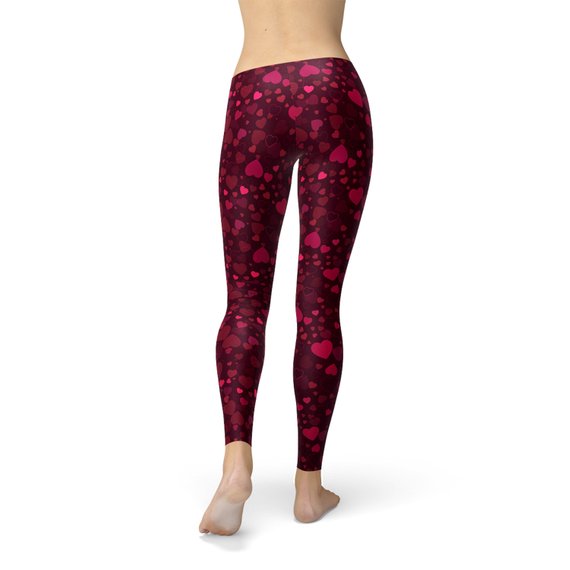 A pair of vibrant red women's leggings featuring a unique hearts design, showcasing their four-way stretch and squat-proof quality, perfect for workouts and casual wear.