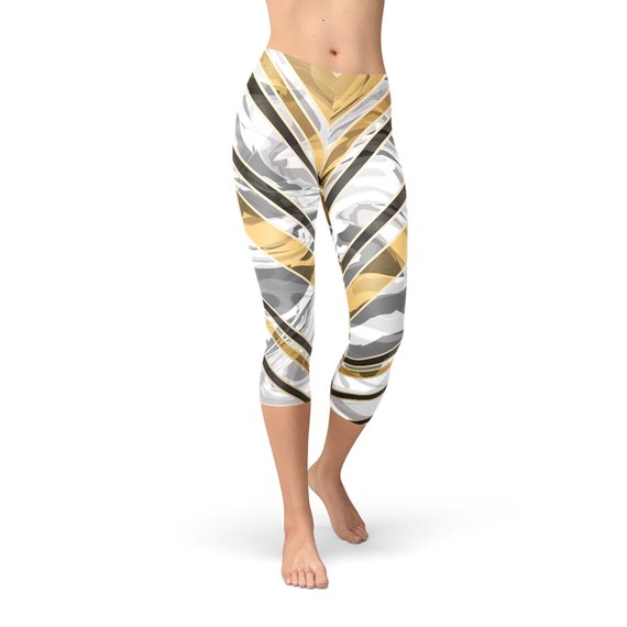 White marble capri leggings with black gold lines, showcasing a stylish and unique design for women's activewear.