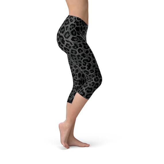 Women's Black Capri Leggings featuring a vibrant leopard spots print, designed for comfort and performance, perfect for workouts and casual wear.