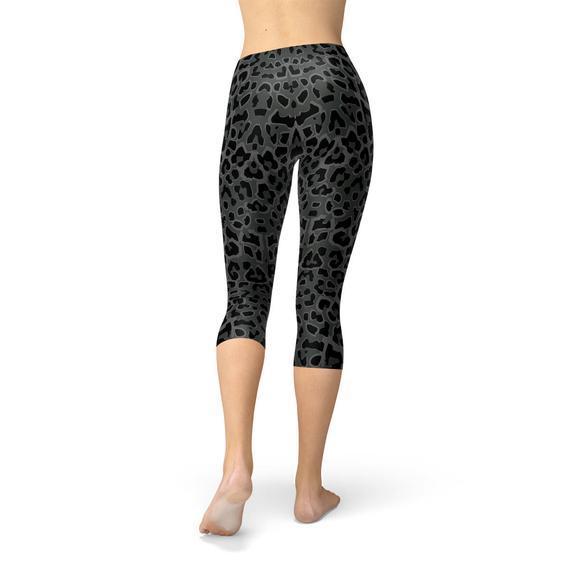 Women's Black Capri Leggings featuring a vibrant leopard spots print, designed for comfort and performance, perfect for workouts and casual wear.