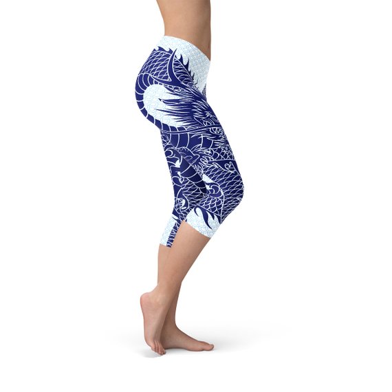 Womens Japanese Dragon Capri Leggings featuring a vibrant dragon tattoo design on a pastel blue scale background, ideal for workouts and casual wear.