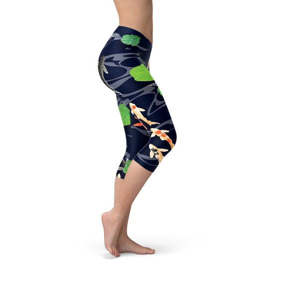 A pair of women's capri leggings featuring a vibrant koi fish design in a serene pond setting, showcasing the unique print and high-quality fabric.