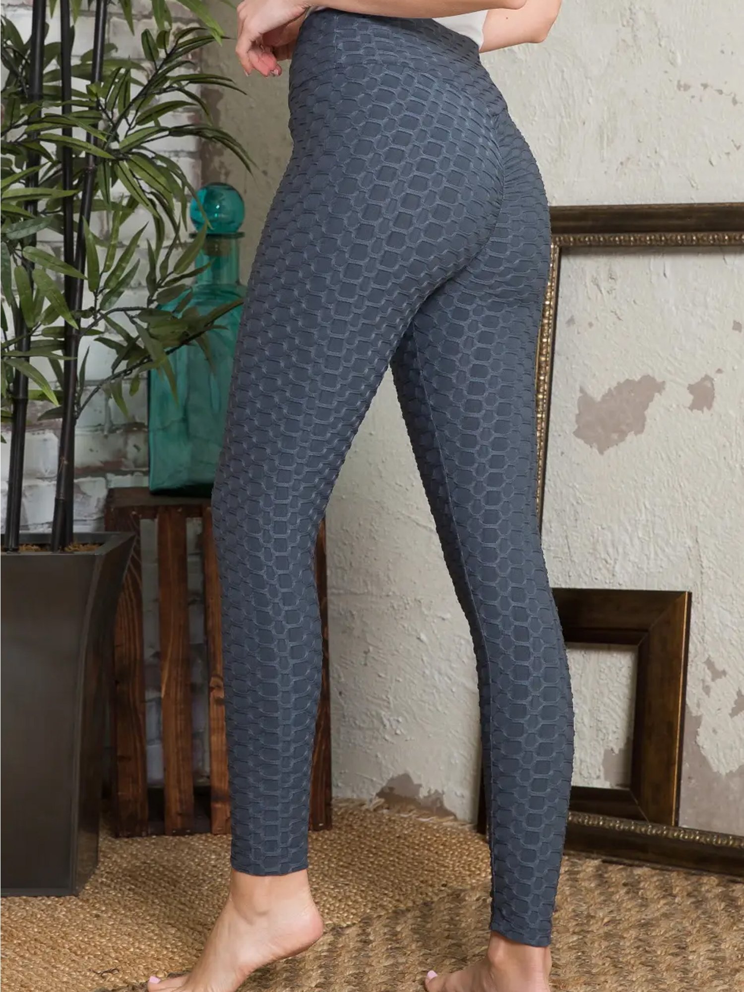 A pair of Women's Bubble Leggings in Black, showcasing the crumple butt design and stretchable fabric, ideal for yoga and fitness activities.