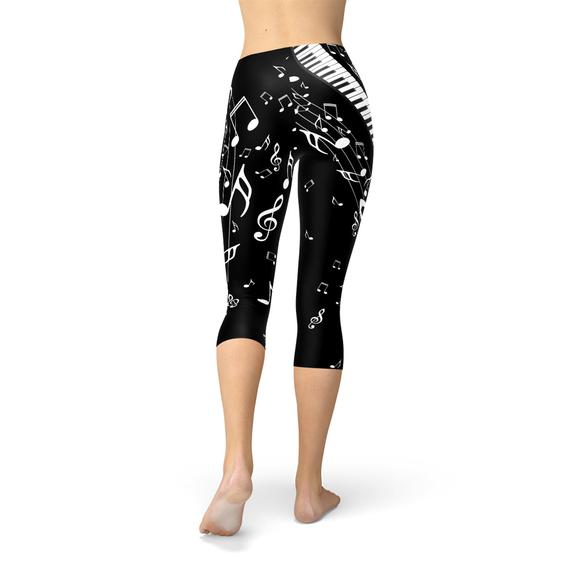 Women's Piano Notes Black Capri Leggings featuring a unique piano notes design, perfect for workouts and casual wear.