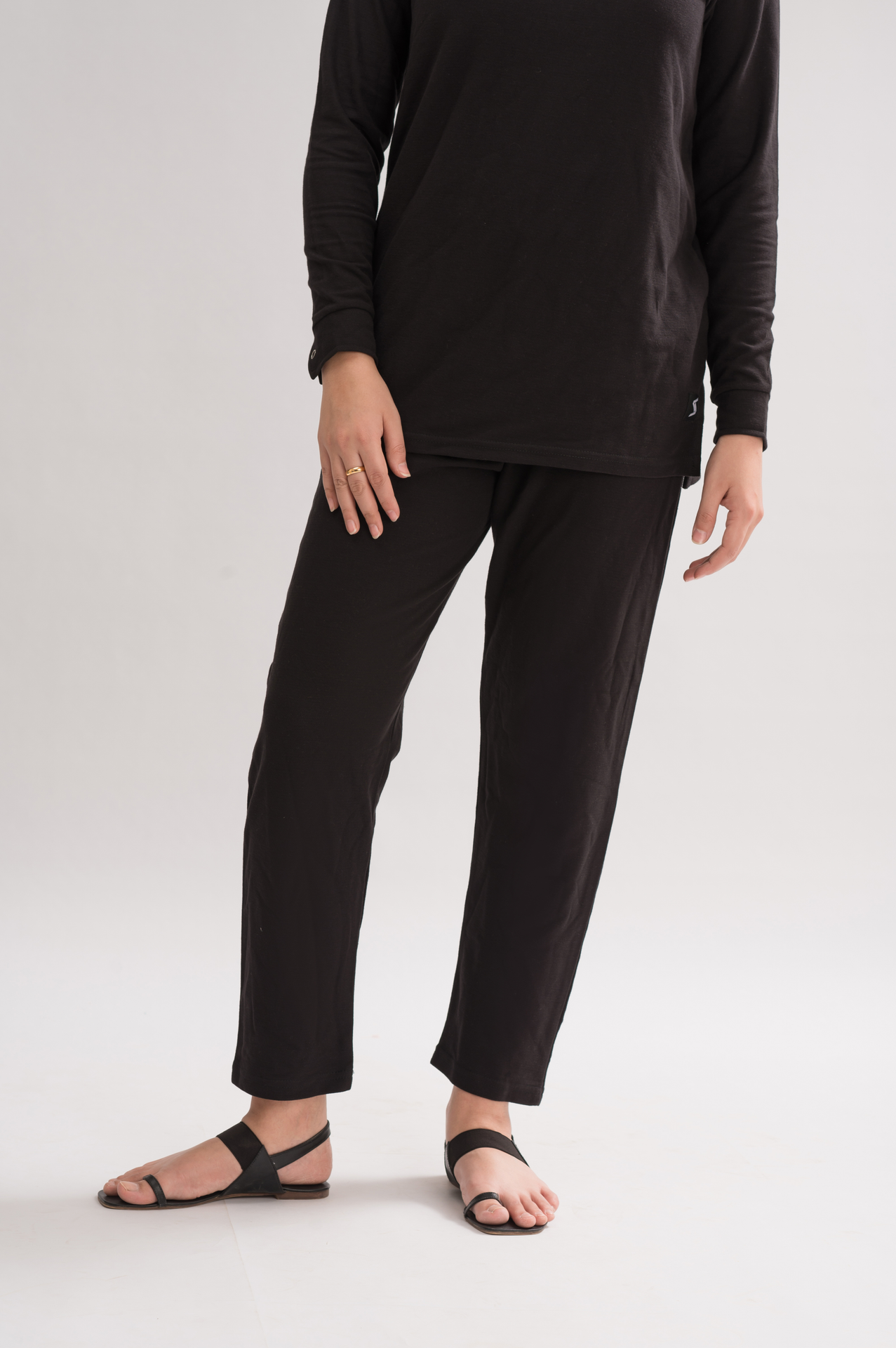 A pair of women's straight fit trousers made from a honeycomb pique cotton blend, featuring an elasticated waistband and a sleek silhouette.