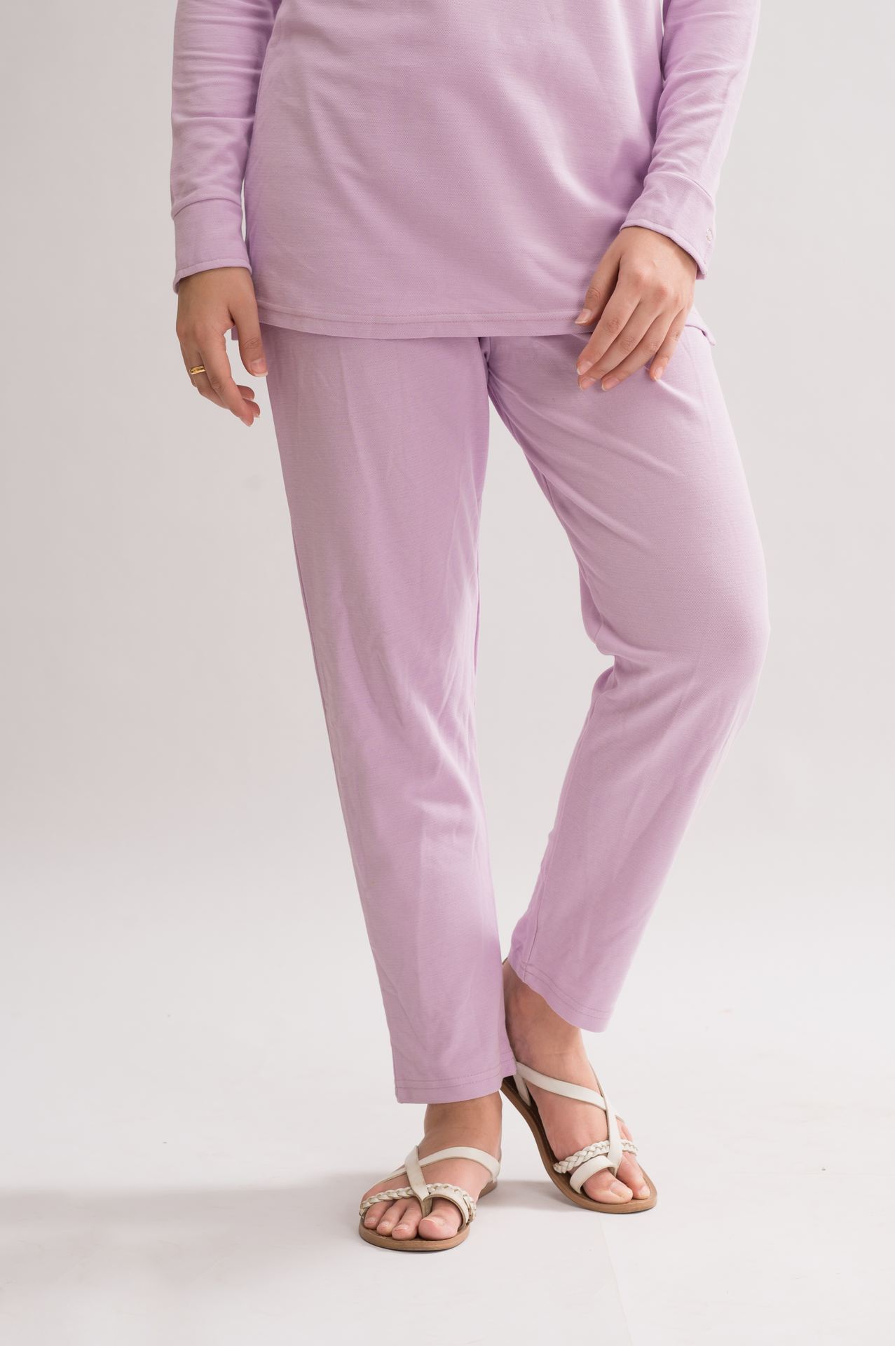 A pair of women's straight fit trousers made from a honeycomb pique cotton blend, featuring an elasticated waistband and a sleek silhouette.