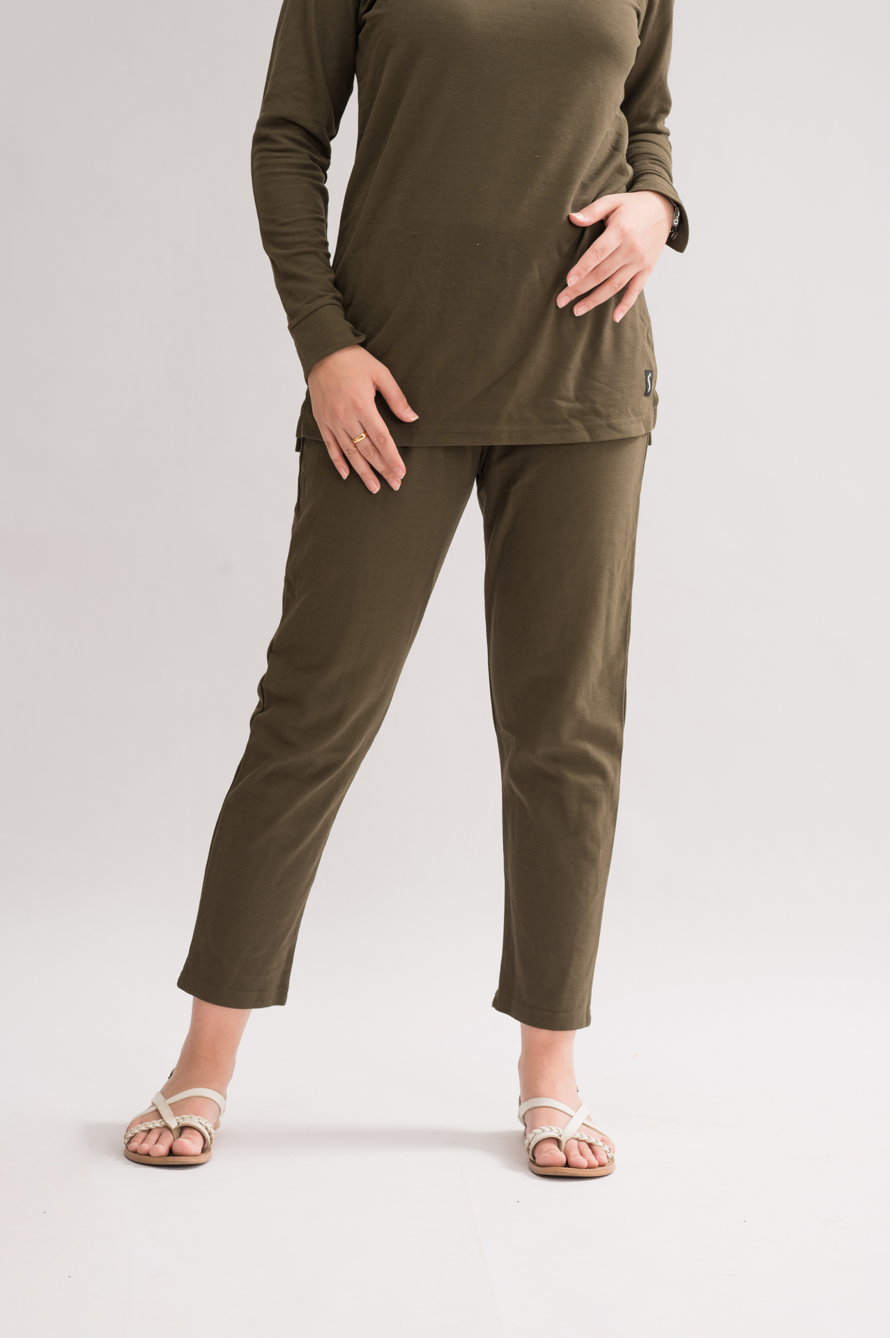 A pair of women's straight fit trousers made from a honeycomb pique cotton blend, featuring an elasticated waistband and a sleek silhouette.