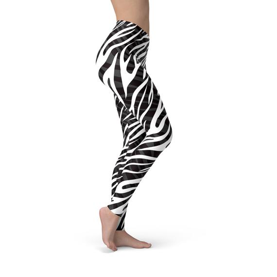 A pair of Womens Zebra Stripes Leggings featuring a bold black and white zebra print design, perfect for workouts and casual wear.