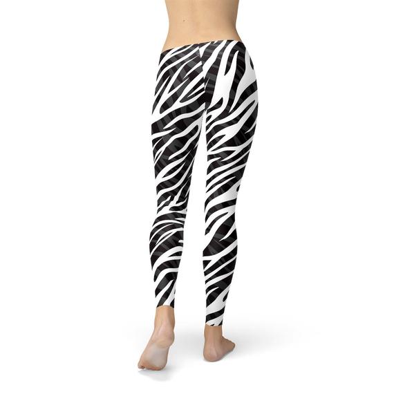 A pair of Womens Zebra Stripes Leggings featuring a bold black and white zebra print design, perfect for workouts and casual wear.