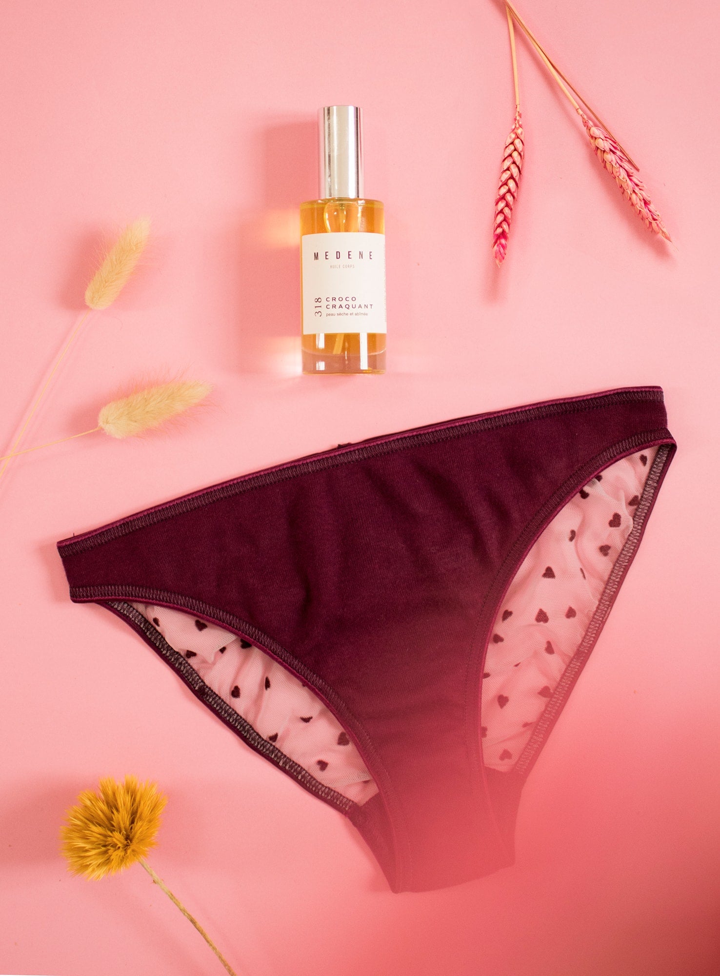 Coffret Love gift set featuring a pink panty with velvet hearts and a bottle of nourishing coconut oil, perfect for Valentine's Day.