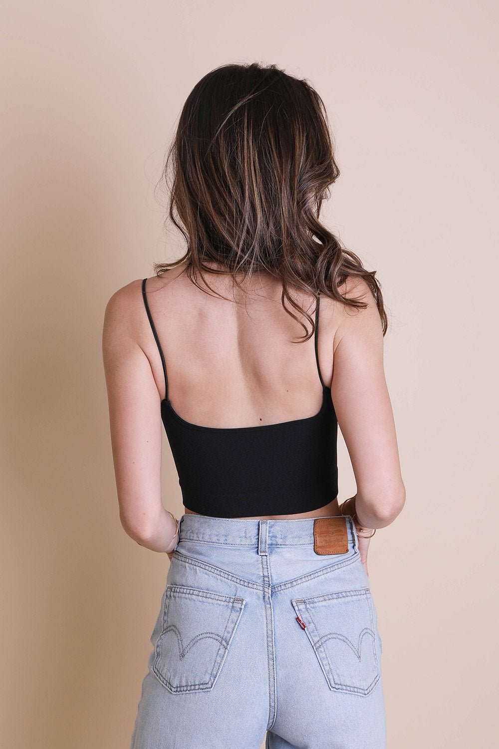 A stylish low back brami top featuring a v-neck design, made from a soft nylon and spandex blend, perfect for casual wear.