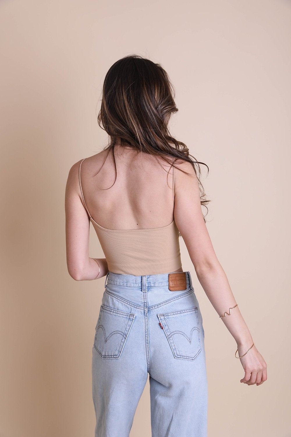 A stylish low back brami top featuring a v-neck design, made from a soft nylon and spandex blend, perfect for casual wear.