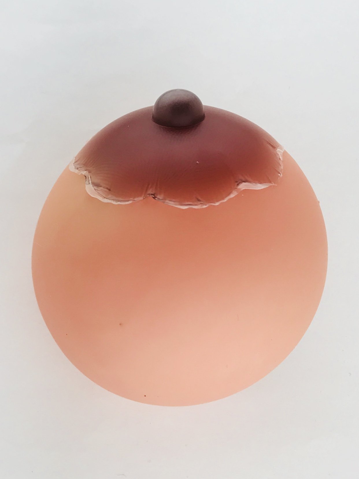 A pair of beige silicone adhesive nipple covers shaped like erect nipples, perfect for costumes and playful occasions.