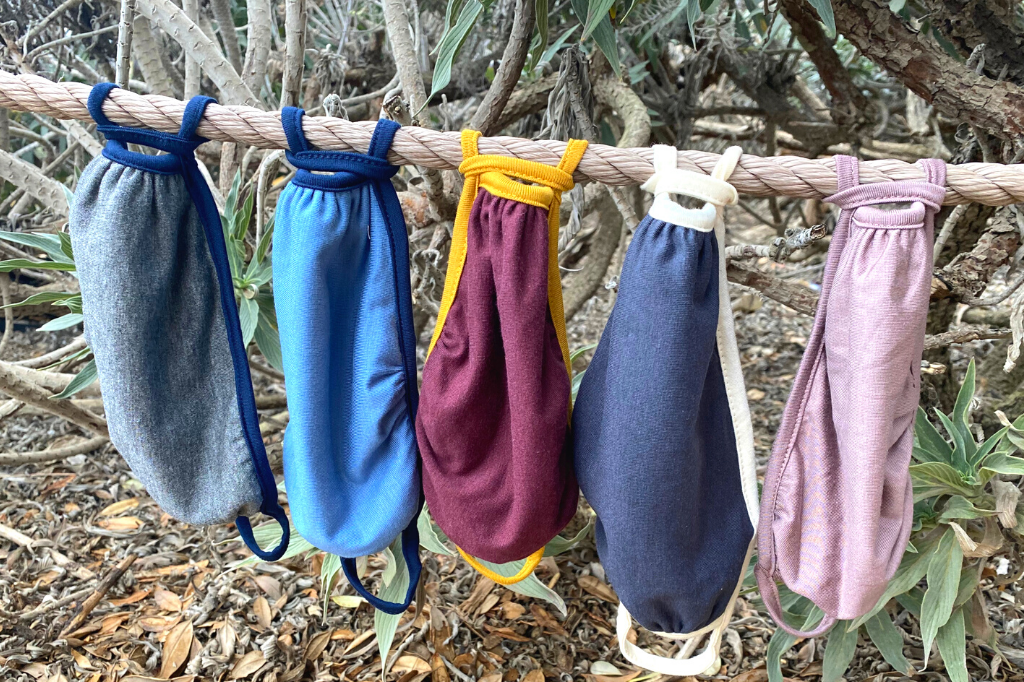 Two Ridiculously Comfy Reusable Cloth Masks in assorted colors, showcasing their soft fabric and stretchy earloops, perfect for everyday wear.