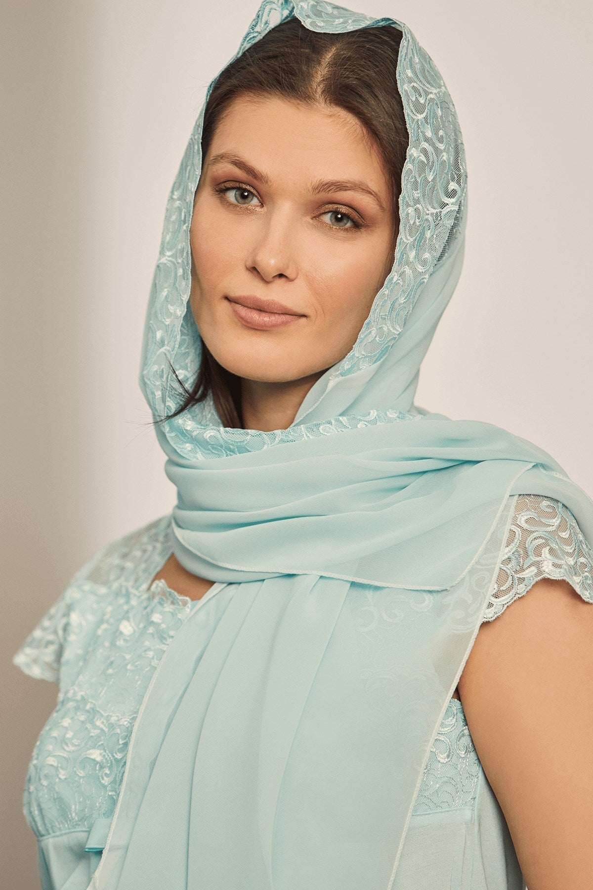 Shopymommy 0019 Turquoise Scarf draped elegantly, showcasing its vibrant color and soft fabric.