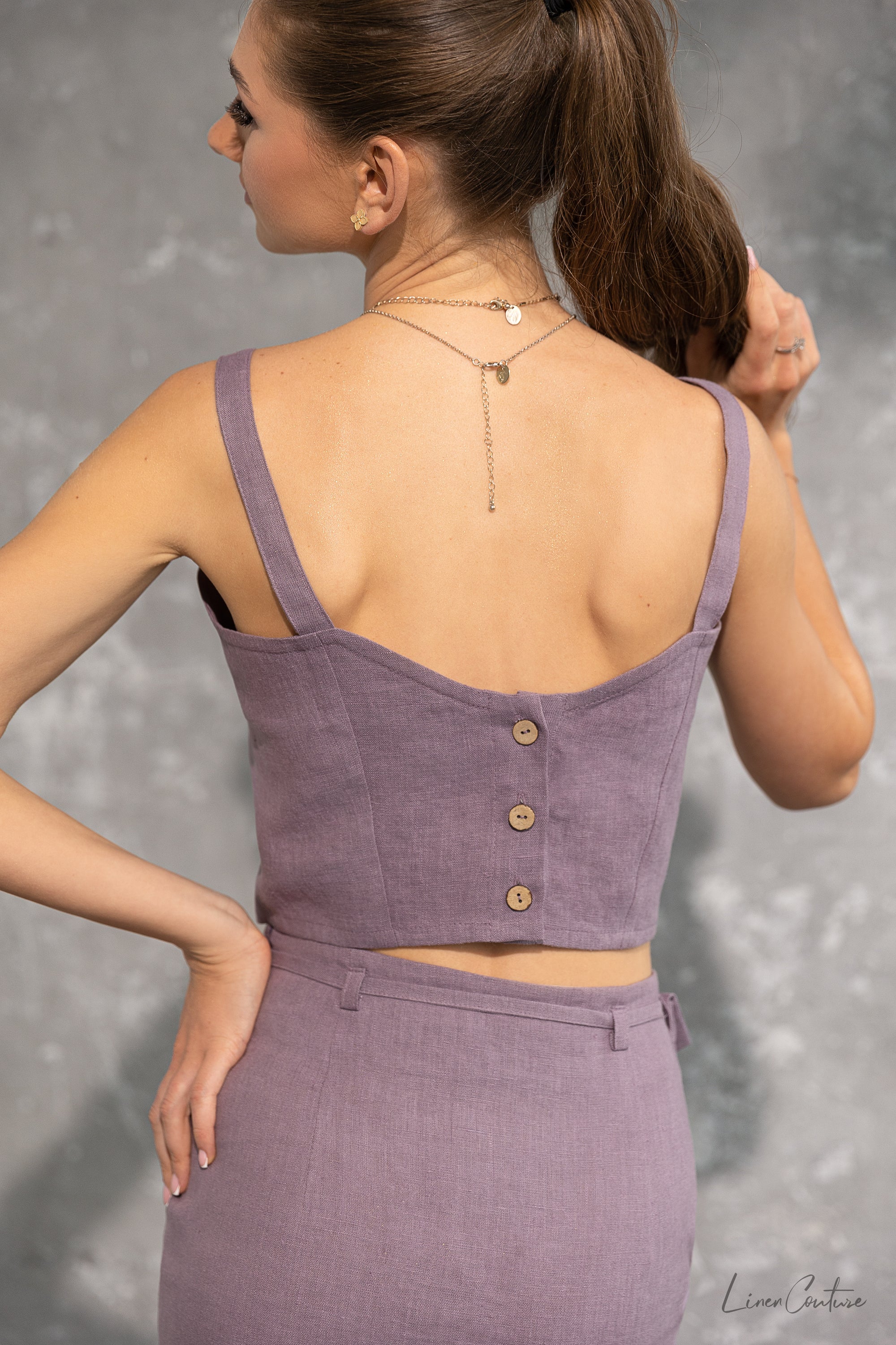 Bella Vita Set in Pastel Plum featuring a linen crop top and midi skirt, elegantly styled on a model.