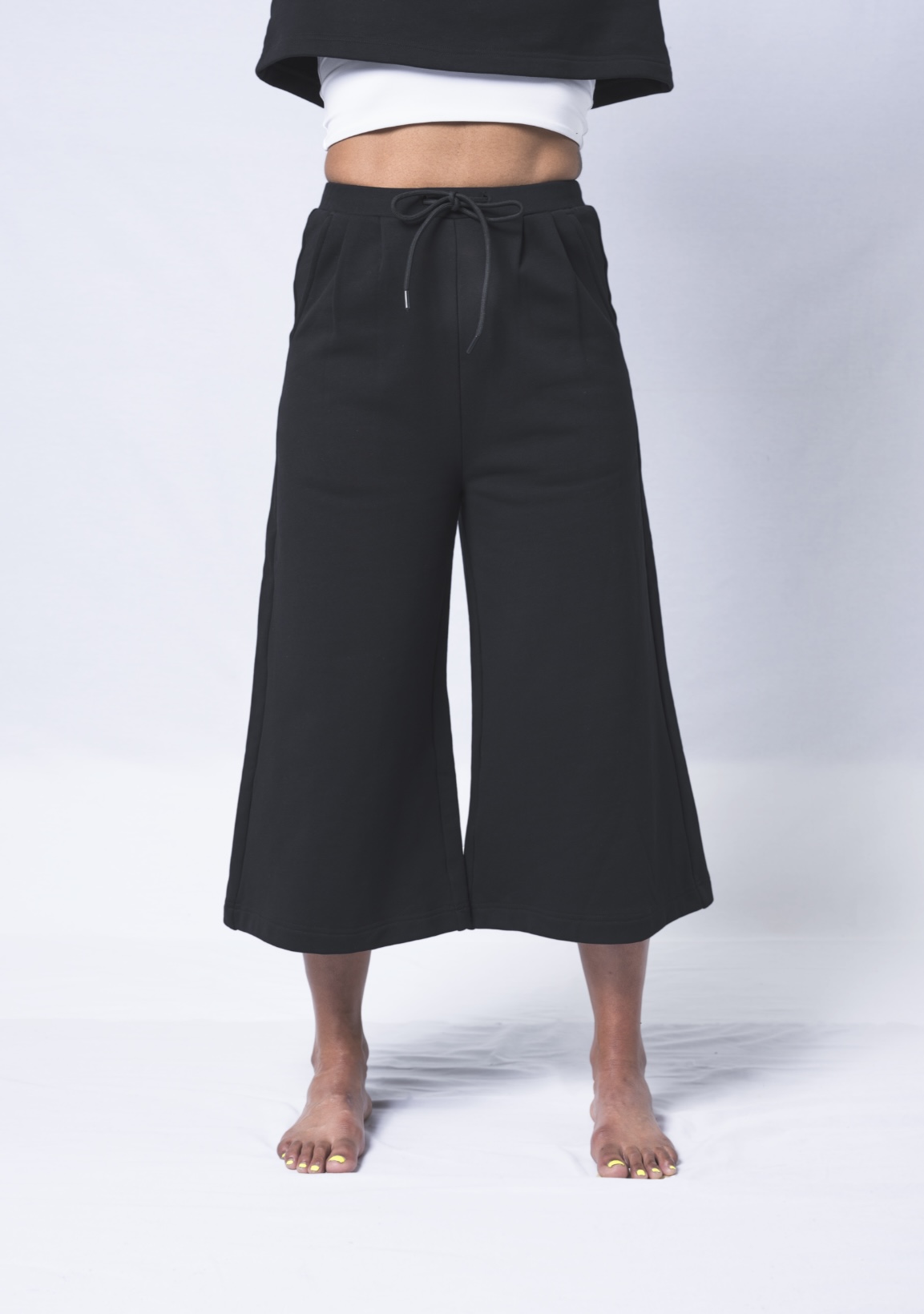 Colette Pants featuring a soft ribbed waistband, deep flat front pockets, and a relaxed fit with a cropped wide leg design, made from heavyweight jersey cotton.